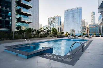 a swimming pool in the middle of a city at Kasco Homes Waves Tower Business Bay in Dubai