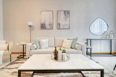 a living room with a couch and a table at Hot Deal Modern 1BR at Iris Blue, Don't Miss Out by Deluxe Holiday Homes in Dubai