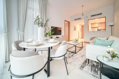 a living room with a table and chairs and a couch at Hot Deal Modern 1BR at Iris Blue, Don't Miss Out by Deluxe Holiday Homes in Dubai