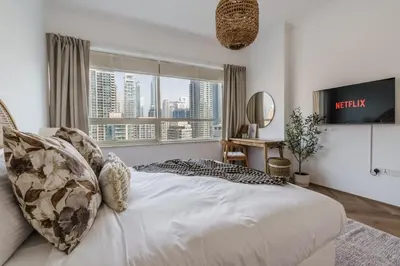 a bedroom with a bed with a view of a city at GuestReady - Bohemian Apt with Marina View in Dubai