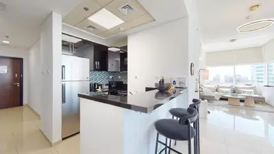 a kitchen with white walls and a counter with stools at BR Luxe 1 BDR Apartment w/ Balcony & Sea Views in Dubai