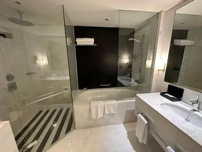 a bathroom with a shower and a sink and a tub at Fashion avenue - Formerly Address Dubai Mall Residence in Dubai