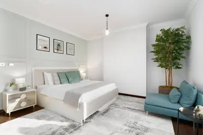 a bedroom with a white bed and a blue chair at Ultimate Stay 2BR Sea View at JBR Beach Ain Dubai High Floor Luxury Stay in Dubai