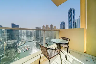 a balcony with a table and chairs and a view of a city at Overlooking Marina Canal Views from Living to Bedroom, The Address Residences, Dubai Marina by Deluxe Holiday Homes in Dubai