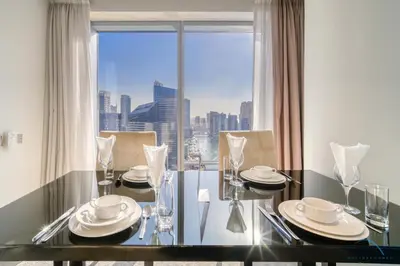 a dining room table with a view of the city at Overlooking Marina Canal Views from Living to Bedroom, The Address Residences, Dubai Marina by Deluxe Holiday Homes in Dubai