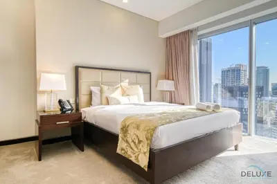 a bedroom with a large bed and a large window at Overlooking Marina Canal Views from Living to Bedroom, The Address Residences, Dubai Marina by Deluxe Holiday Homes in Dubai