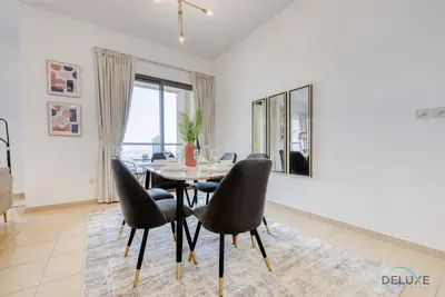 a dining room with a table and chairs at Vogue 2BR at Shams 2 JBR by Deluxe Holiday Homes in Dubai