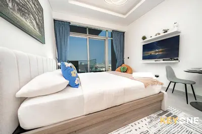 a bedroom with a large bed and a window at Farhad Exclusive Studio Suite in Dubai