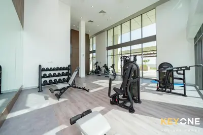 a gym with treadmills and exercise equipment in a building at Farhad Exclusive Studio Suite in Dubai