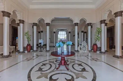 a lobby with a table with flowers on it at Fully-equppied studio with private beach and pool in Dubai