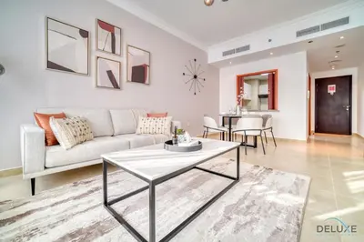 a living room with a couch and a table at Opulent 1BR at MAG 218 Dubai Marina by Deluxe Holiday Homes in Dubai
