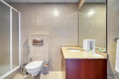 a bathroom with a toilet and a sink at Opulent 1BR at MAG 218 Dubai Marina by Deluxe Holiday Homes in Dubai