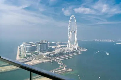 a large ferris wheel in the middle of the water at Lux BnB I The Address JBR I Ocean View in Dubai