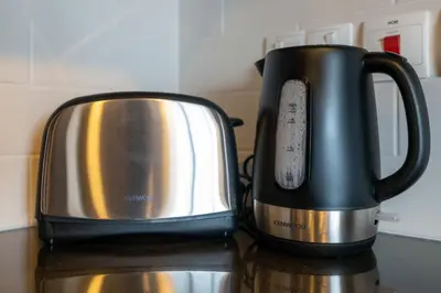 two black and silver coffee pots sitting on a counter at Lux BnB I 29 Burj BLVD I Downtown Views in Dubai