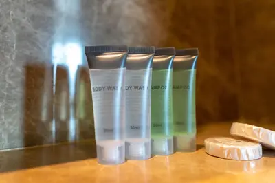 a group of four bottles of moisturizers sitting on a table at Lux BnB I 29 Burj BLVD I Downtown Views in Dubai