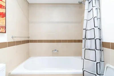 a bathroom with a tub and a shower at Lux BnB I 29 Burj BLVD I Downtown Views in Dubai