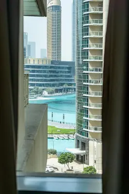 a view of the ocean from a window of a building at BellaVista 29 Boulevard 1 Bedroom Apartment with Extra Bedroom Partial Fountain Views in Dubai