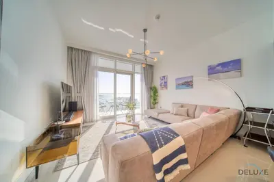 a living room with a couch and a large window at Splendid 2BR at Sunrise Bay Tower 1 Emaar Beachfront Dubai Marina by Deluxe Holiday Homes in Dubai
