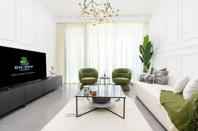 a living room with a couch and a tv at ON OFF HH- CREEK HARBOUR-Lavish Parisian 2 BR in Dubai
