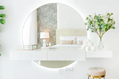 a white bedroom with a mirror and a bed at ON OFF HH- CREEK HARBOUR-Lavish Parisian 2 BR in Dubai
