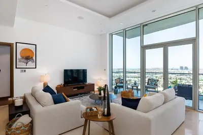 a living room with white furniture and glass windows at Oceana Residences, The Palm Jumeirah - Mint Stay in Dubai