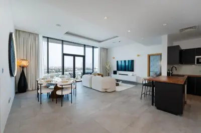 a dining room and living room with a table and chairs at Oceana Residences, The Palm Jumeirah - Mint Stay in Dubai