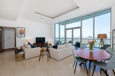 a living room with a table and chairs and glass windows at Oceana Residences, The Palm Jumeirah - Mint Stay in Dubai