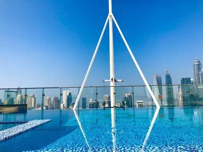 a pool with a city skyline in the background at Luxury Modern Studio in JLT - Rooftop Pool - Lake Area Upgrades Ongoing in Dubai