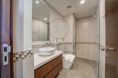 a bathroom with a sink and a shower and a toilet at Modern City Retreat Vera Residence, Business Bay in Dubai