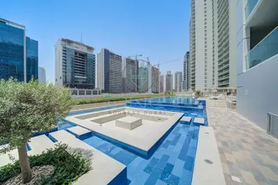 a pool in the middle of a city with tall buildings at Modern City Retreat Vera Residence, Business Bay in Dubai