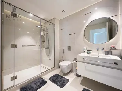a bathroom with a shower and a toilet and a sink at Mira Holiday Homes - Newly 1 bedroom apartment with beach access in Dubai