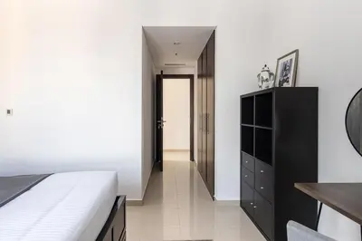 a bedroom with a bed and a black cabinet at Frank Porter - Bay Central West 2 in Dubai