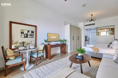 a living room with a couch and a table at bnbme - Palm Jumeirah Studio Balcony Sea Ain Dubai Views Pool Gym Parking Access in Dubai
