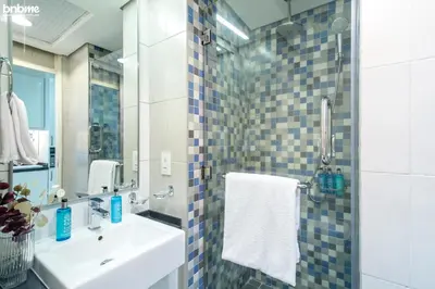 a bathroom with a sink and a mirror at bnbme - Palm Jumeirah Studio Balcony Sea Ain Dubai Views Pool Gym Parking Access in Dubai