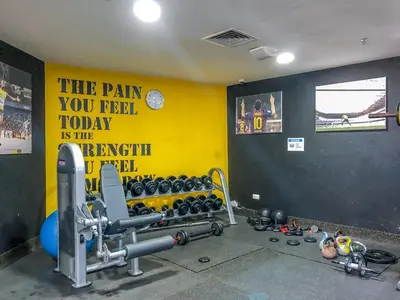 a room with a gym with a sign on the wall at GuestReady - Chic Studio in Urban JLT in Dubai