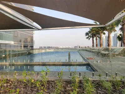 a swimming pool in the middle of a building at Gharfar-2 Heaven Escape-Golf view-high floor-Netflix-GYM-Pool-perfect staycation in Dubai