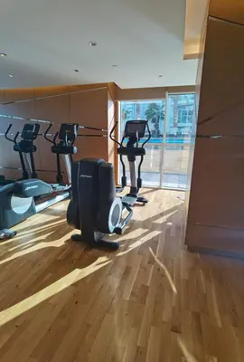 a gym with several treadying machines in a room at Gharfar-2 Heaven Escape-Golf view-high floor-Netflix-GYM-Pool-perfect staycation in Dubai