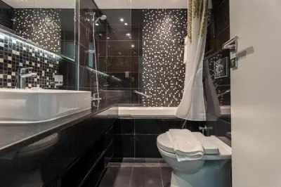 a bathroom with a sink and a toilet and a shower at GuestReady - Stylish Galore near Dubai Fountain in Dubai