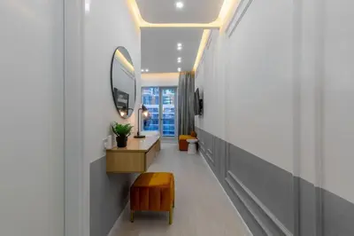 a hallway with a vanity and a mirror and a stool at Horizon Tower - Stunning Four Bedroom in Dubai