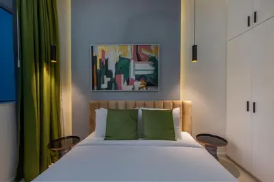 a bedroom with a large bed with green curtains at Horizon Tower - Stunning Four Bedroom in Dubai