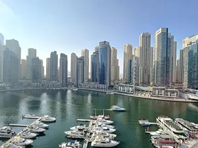 a group of boats docked in a harbor in a city at Al Majara 2 - Gorgeous One Bedroom in Dubai