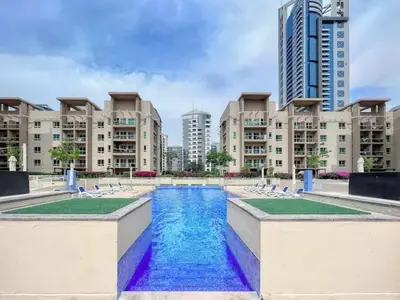 a large swimming pool in a city with buildings at Gorgeous One Bedroom Apartment in the heart of Dubai in Dubai