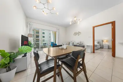 a dining room and living room with a table and chairs at Gorgeous One Bedroom Apartment in the heart of Dubai in Dubai