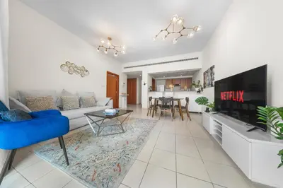 a living room with a couch and a tv at Gorgeous One Bedroom Apartment in the heart of Dubai in Dubai
