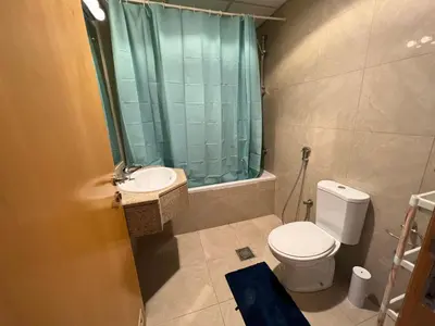 a bathroom with a toilet and a sink and a shower at Marina Crown Tower Stays Hostel for Girls in Dubai