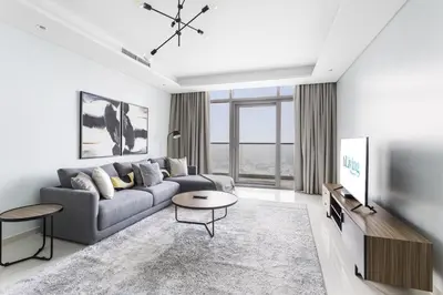 a living room with a couch and a tv at ALiving Luxury 2BR with Infinity Pool I Near Dubai Mall & Burj Khalifa I Paramount Hotel Midtown in Dubai