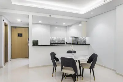 a dining room with a table and chairs at ALiving Luxury 2BR with Infinity Pool I Near Dubai Mall & Burj Khalifa I Paramount Hotel Midtown in Dubai