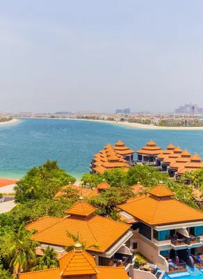 an aerial view of a resort with orange roofs and the ocean at EDEN'S Homes & Villas - Anantara The Palm Residences in Dubai