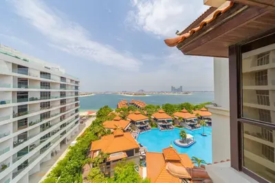 an aerial view of a resort with a swimming pool at EDEN'S Homes & Villas - Anantara The Palm Residences in Dubai