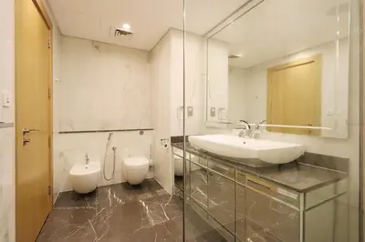 a bathroom with a sink and a toilet at Livbnb Suites - 1BR with Sea View & Beach Access in Dubai